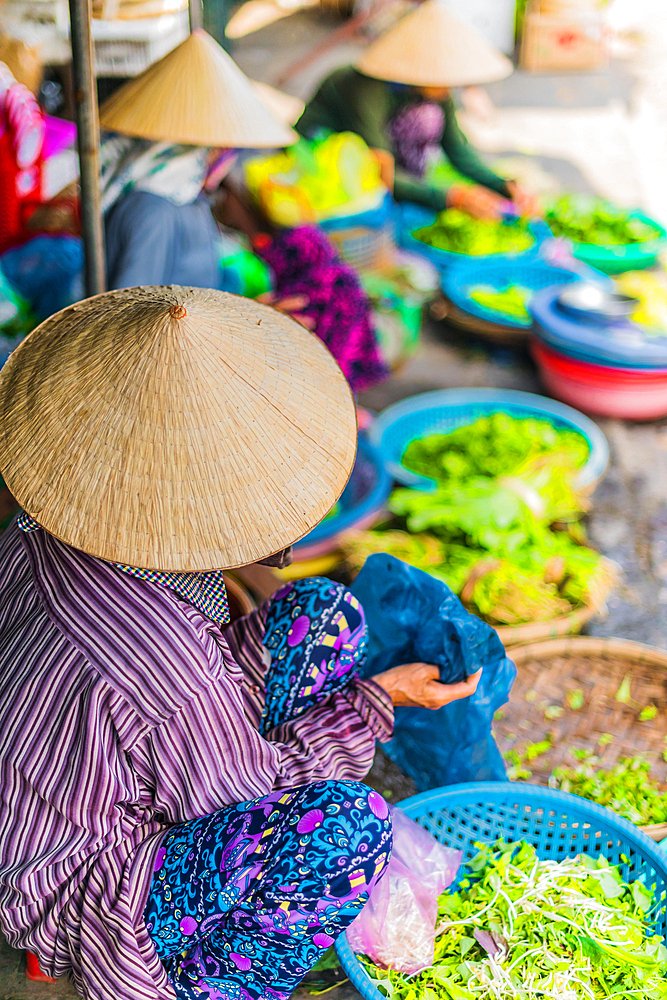 Women selling food on the street of Hoi An in Quang Nam Province, Vietnam, Asia