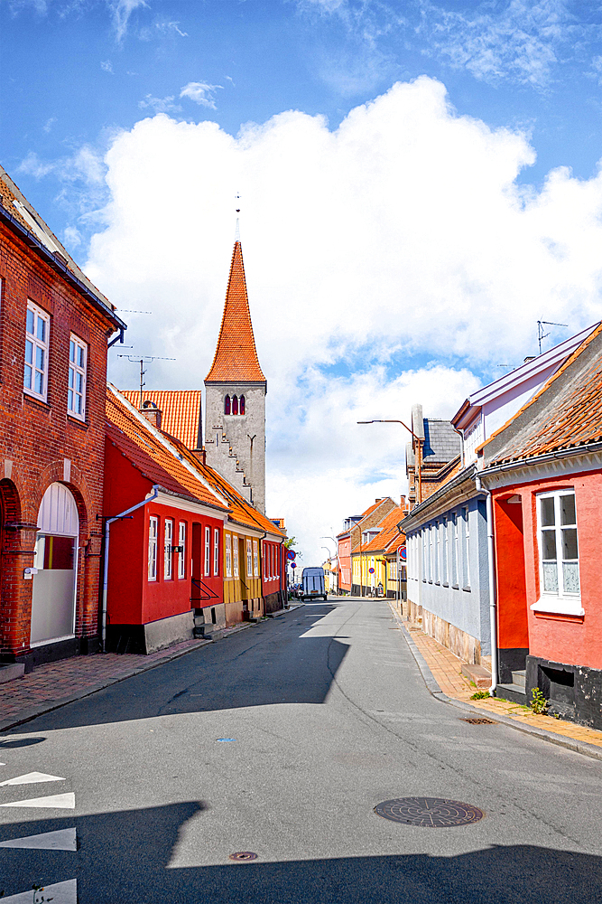 Village with a church in Denmark under a blue sky in the summer