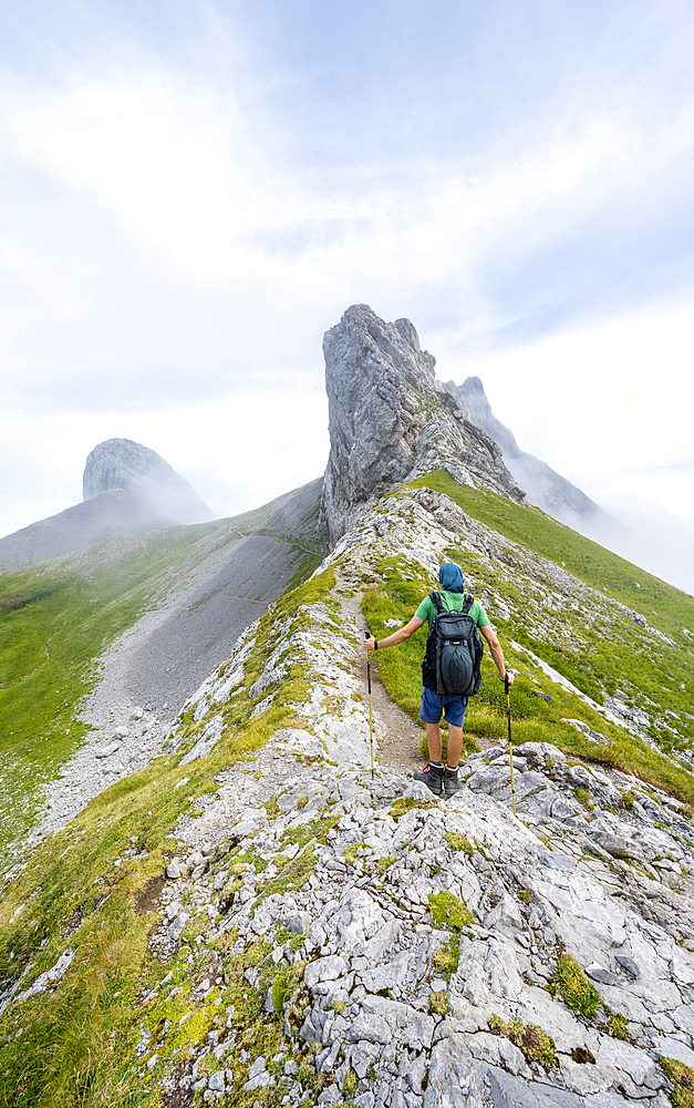 Mountaineer at Hoech-Niederi Sattel, rocky ridge, Saentis, Appenzell Ausserrhoden, Appenzell Alps, Switzerland, Europe