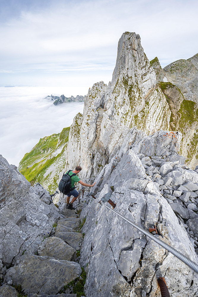 Mountaineer on the Lisengrat, narrow ridge path on the ascent to Saentis, Appenzell Ausserrhoden, Appenzell Alps, Switzerland, Europe