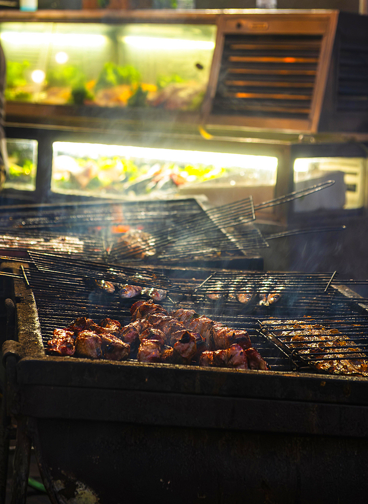 Fish and meat on a grill of a restaurant in the old town of Lisbon, Portugal, Europe