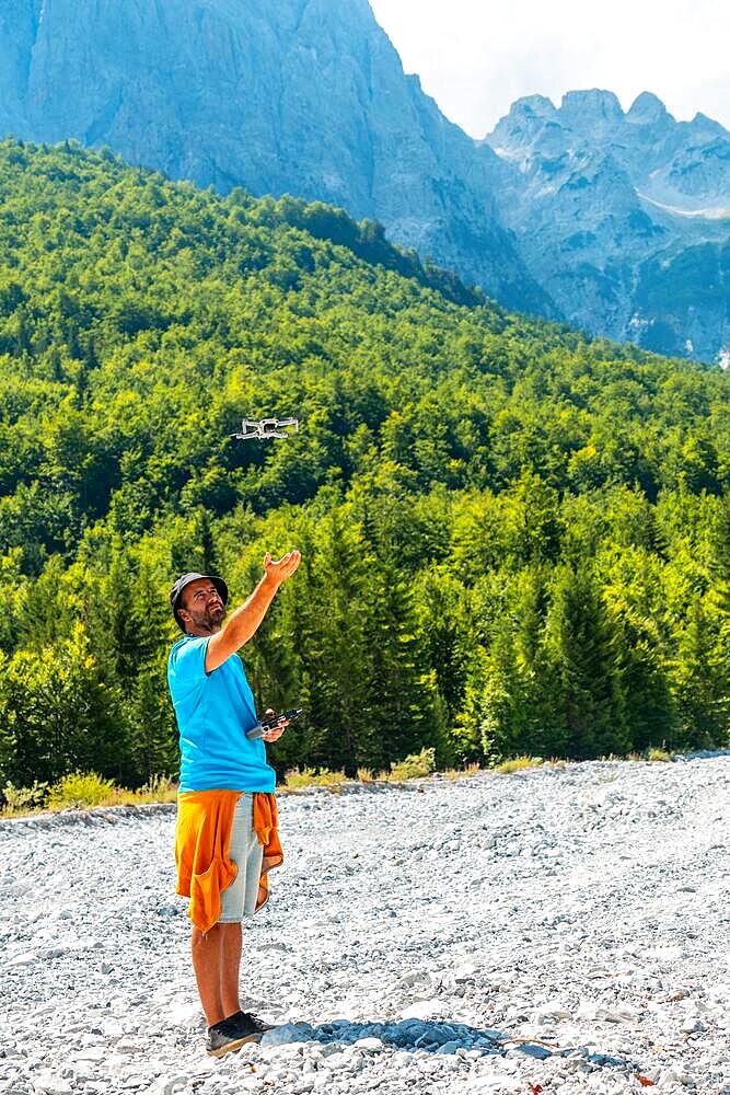 Drone pilot man taking off exploring new places in the mountain. Use of drone photography