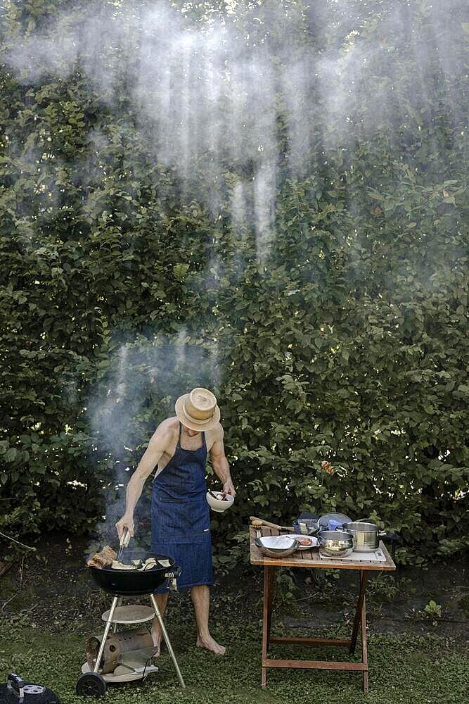 Man barbecuing in the garden