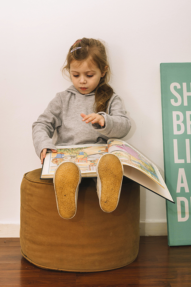 Cute girl reading pouf