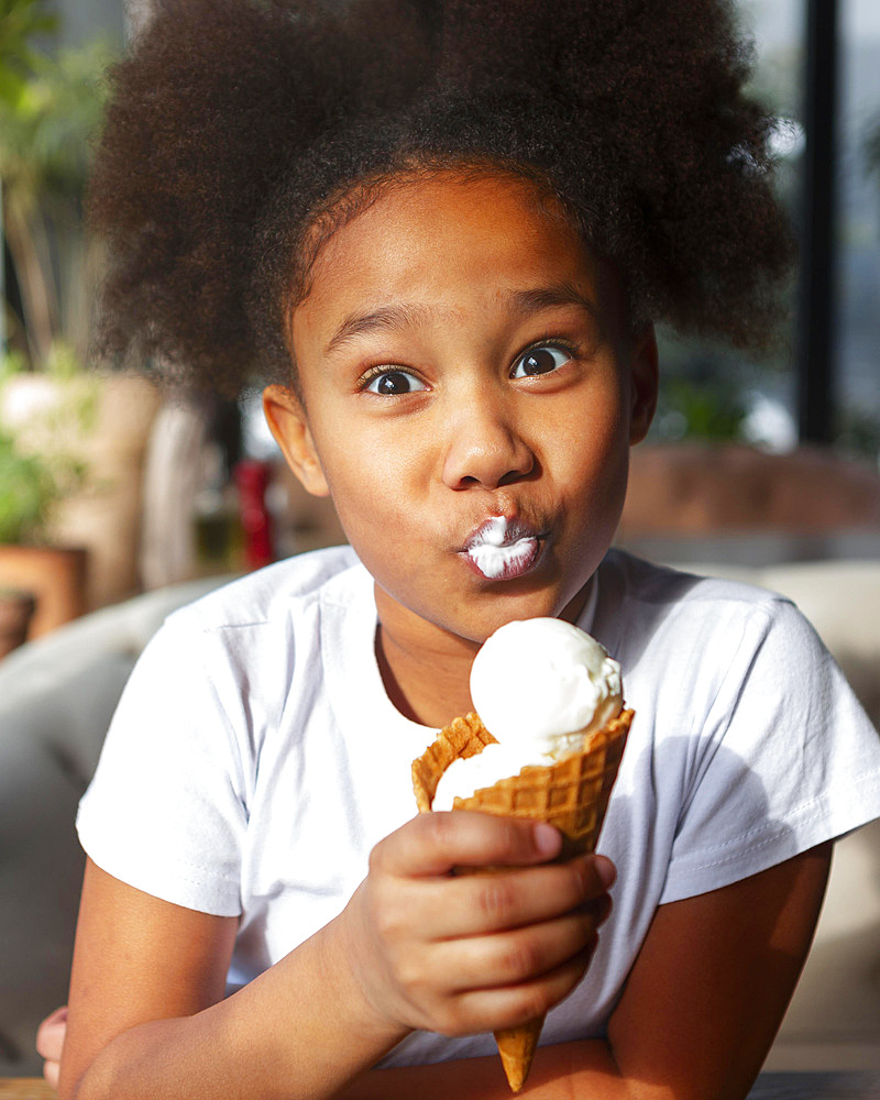 Medium shot girl eating ice cream