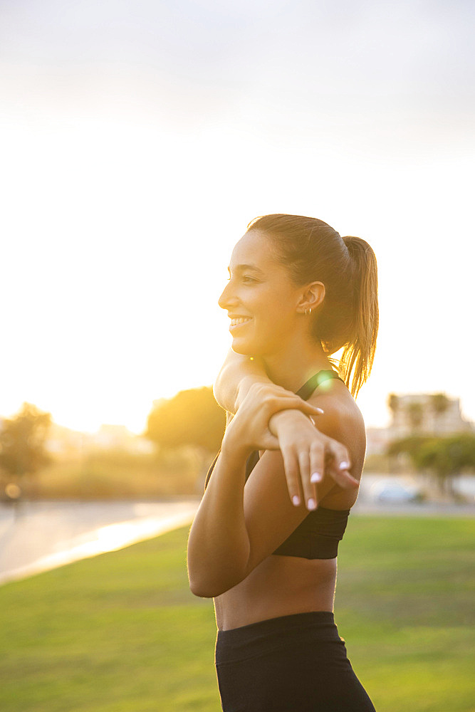 Medium shot smiley woman stretching