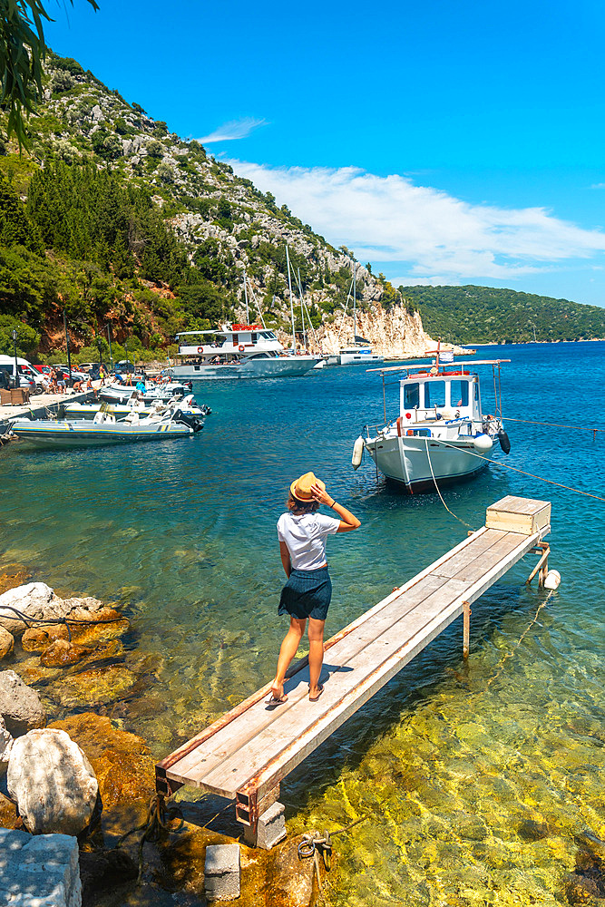 Portrait of a woman walking in the port of Frikes on the island of Ithaki or Ithaca, Ionian sea, Greece, Europe