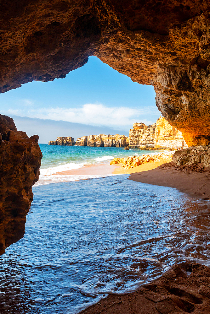 A cave entering the water from the beach at Praia da Coelha, Algarve, Albufeira. Portugal