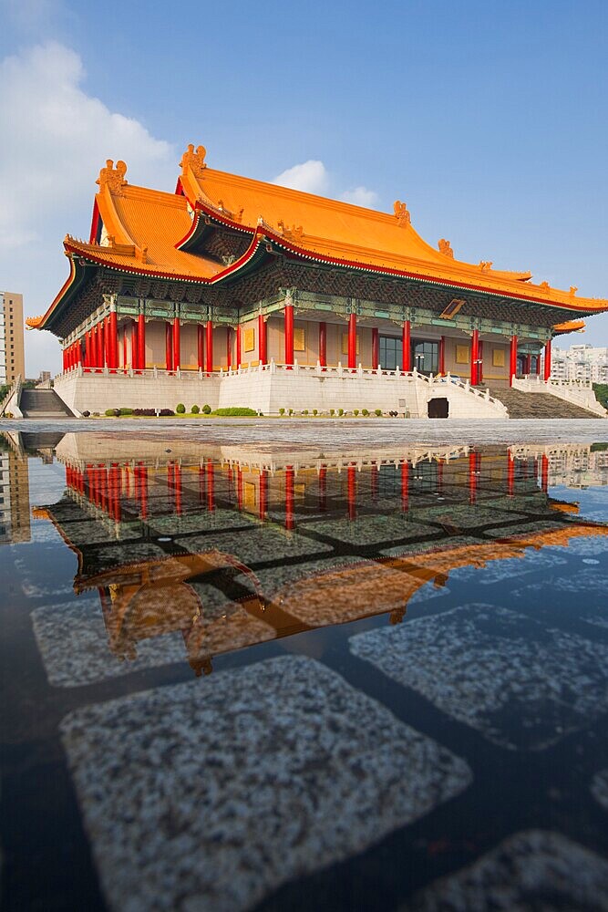 Taipei National Concert Hall beautifully reflected in a puddle of rainwater