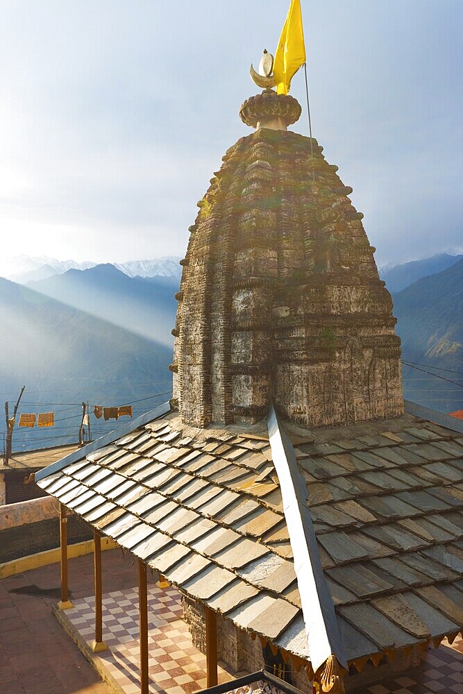 A minor temple at Bhimakali Temple complex overlooks the view of the Himalayas in Sarahan, Himachal Pradesh, India. Vertical