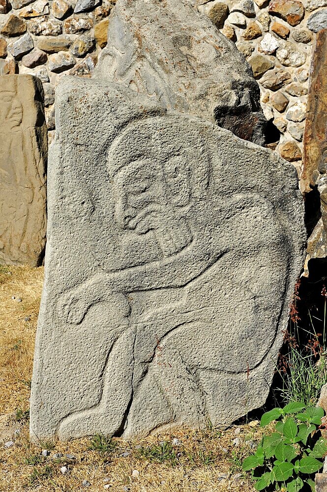 Unesco World Heritage Site Monte Alban, Oaxaca, Mexico, Central America, Ancient relief of a man carved into a light brown stone, surrounded by plants, Mitla, Central America