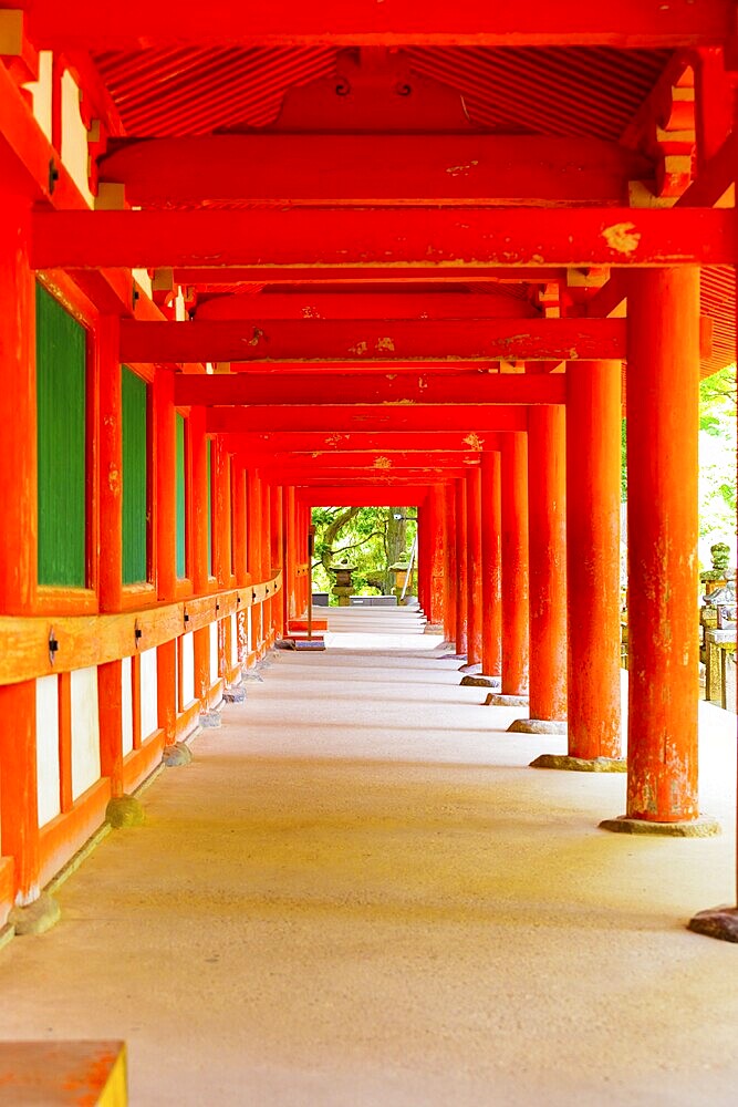 Repeating red columns of an outdoor hallway around outside of Kasuga-Taisha Shinto shrine at Todai-ji temple complex in Nara, Japan, Asia