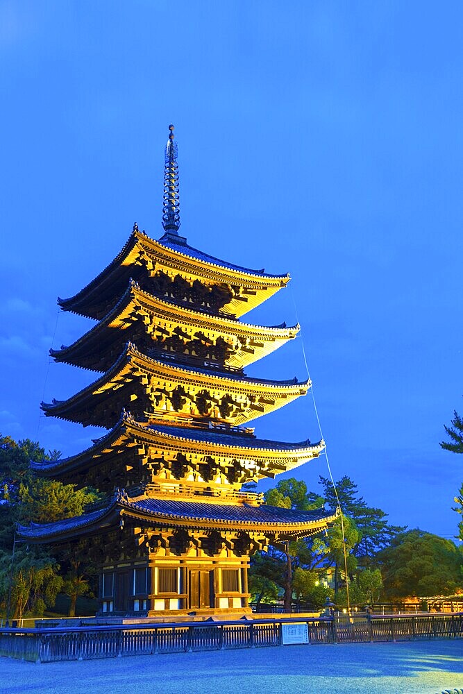 Beautiful blue sky and lighted five story pagoda, goju-no-to, at evening blue hour in Kofuku-ji temple complex in Nara, Japan, Asia