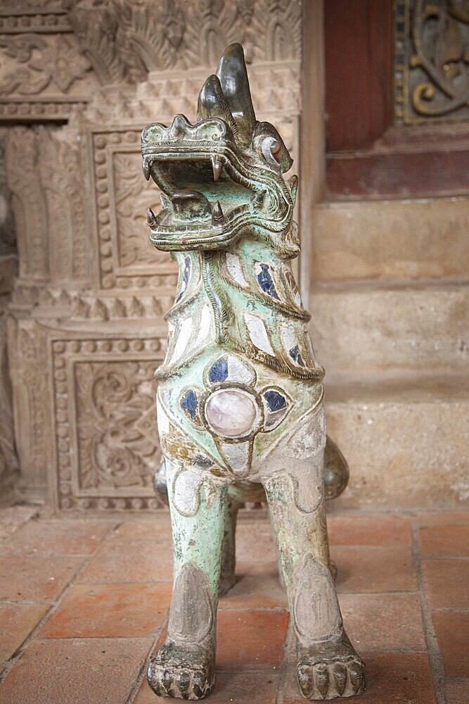 Dog-lion statue decorated with stones. Wat Ho Phra Keo (Altar of the Emerald Buddha), Vientiane, Laos, Asia