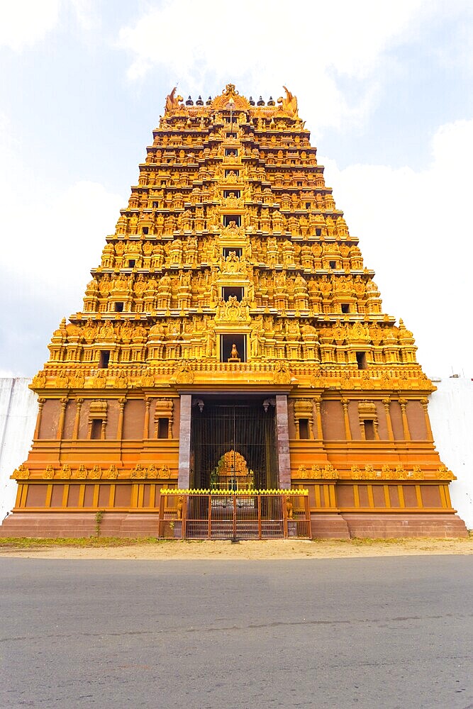 Centered front of the Golden Entrance gopuram tower, Swarna Vaasal, of the Nallur Kandaswamy Kovil Hindu Temple along the main road in Jaffna, Sri Lanka, Asia