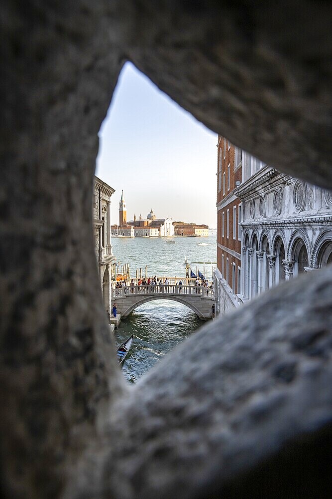 View from the Bridge of Sighs through a small hatch, Ponte della Paglia bridge and San Giorgio Maggiore church, prison, Doge's Palace, Venice, Veneto, Italy, Europe