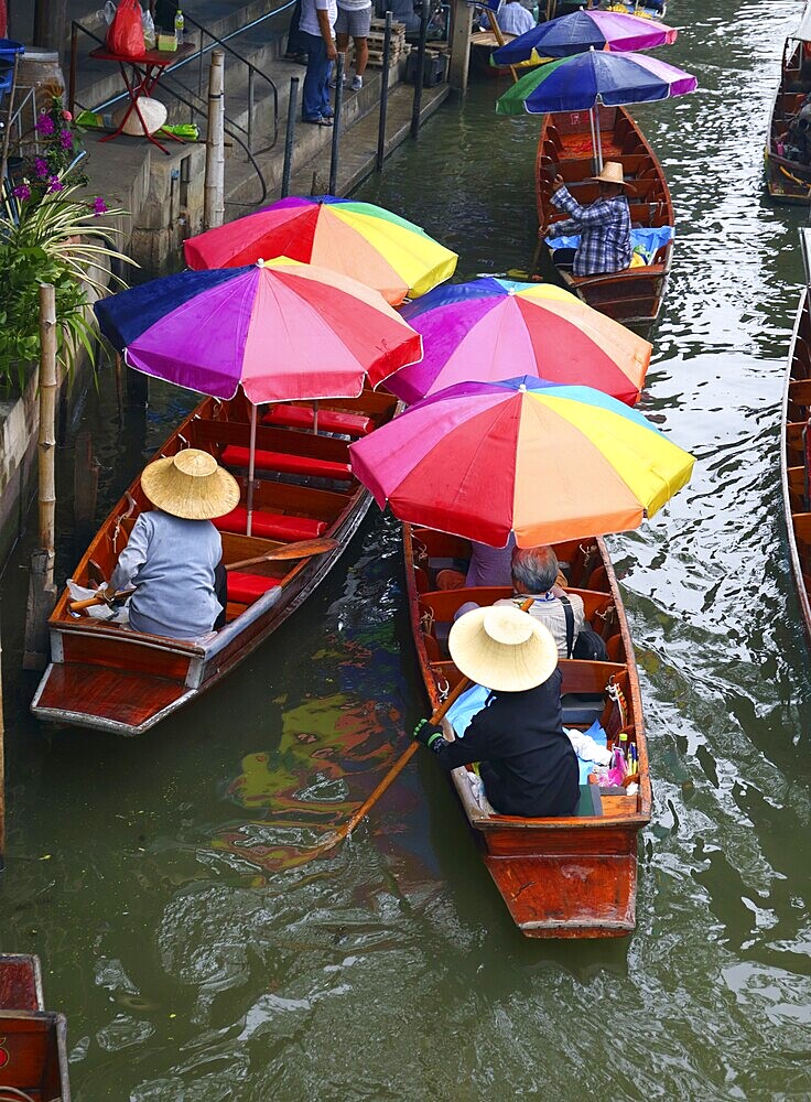 Boats with umbrella on floating market Damnoen Saduak in Bangkok, Thailand, Asia