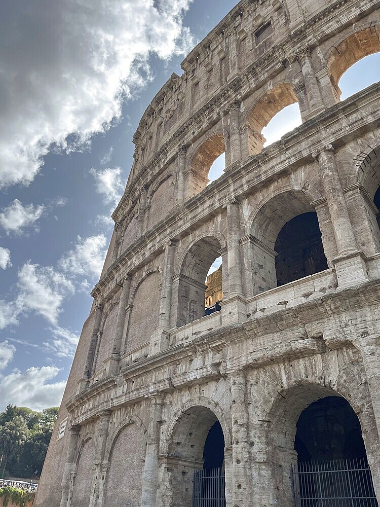 Architectural details of the Colosseum with clouds in the background, Rome, Italy