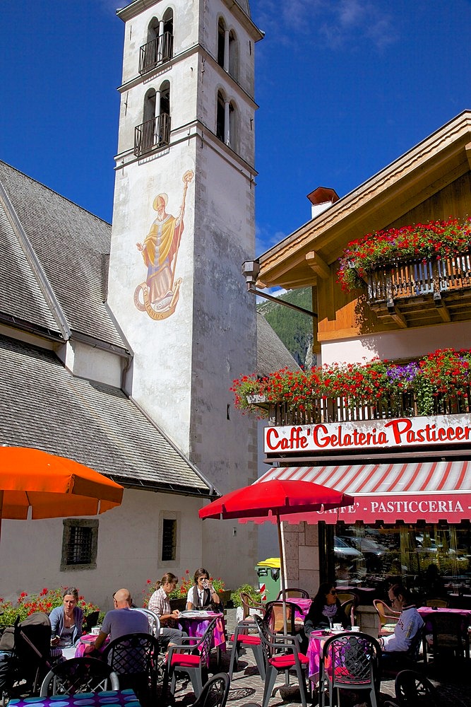 Church and cafe, Alleghe, Belluno Province, Veneto, Dolomites, Italy, Europe