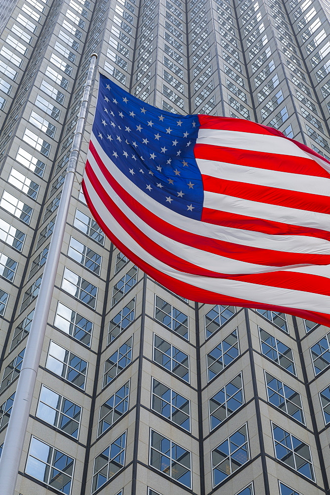 American flag set against skyscraper building windows in Downtown Miami, Miami, Florida, United States of America, North America