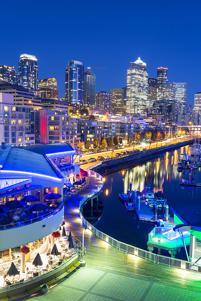 Elevated view of Seattle skyline and restaurants in Bell Harbour Marina at dusk, Belltown District, Seattle, Washington State, United States of America, North America