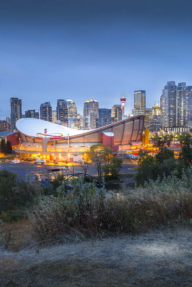 View of the Saddledome and Downtown skyline from Scottsman Hill at dusk, Calgary, Alberta, Canada, North America