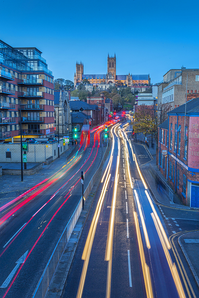 View of Lincoln Cathedral and traffic on Broadgate at dusk, Lincoln, Lincolnshire, England, United Kingdom, Europe