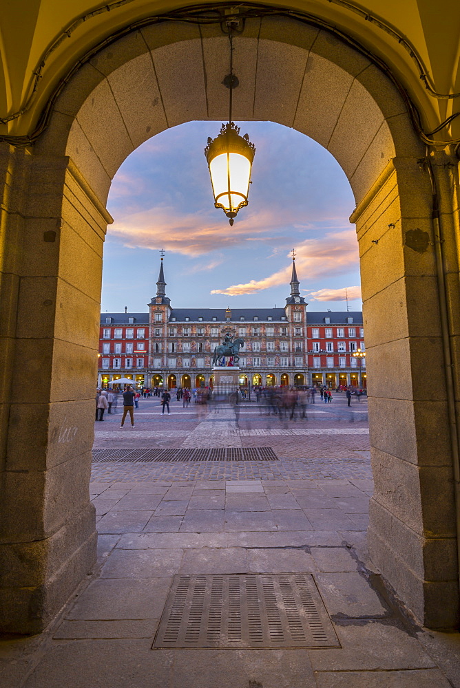 View of Casa de la Panaderia in Plaza Mayor through archway at dusk, Madrid, Spain, Europe