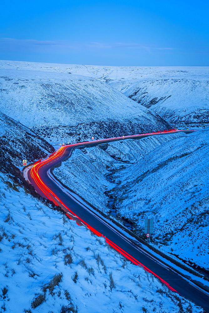 Winter landscape and trail lights on Snake Pass, Peak District National Park, Derbyshire, England, United Kingdom, Europe