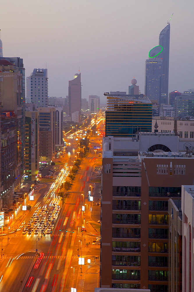 City skyline and Rashid Bin Saeed Al Maktoum Street at dusk, Abu Dhabi, United Arab Emirates, Middle East