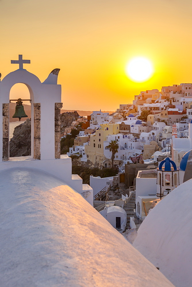 View of traditional blue domed churches and white houses at sunset in Oia, Santorini, Cyclades, Aegean Islands, Greek Islands, Greece, Europe