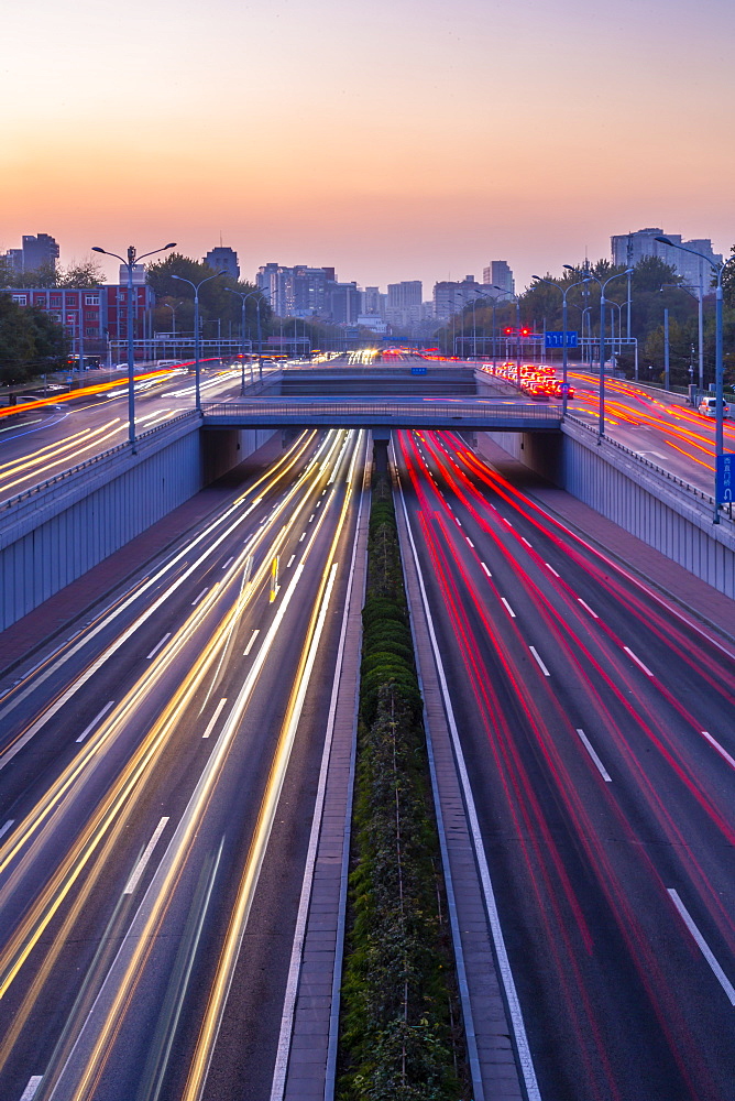 Traffic trail lights on major road near Beijing Zoo at dusk, Beijing, People's Republic of China, Asia