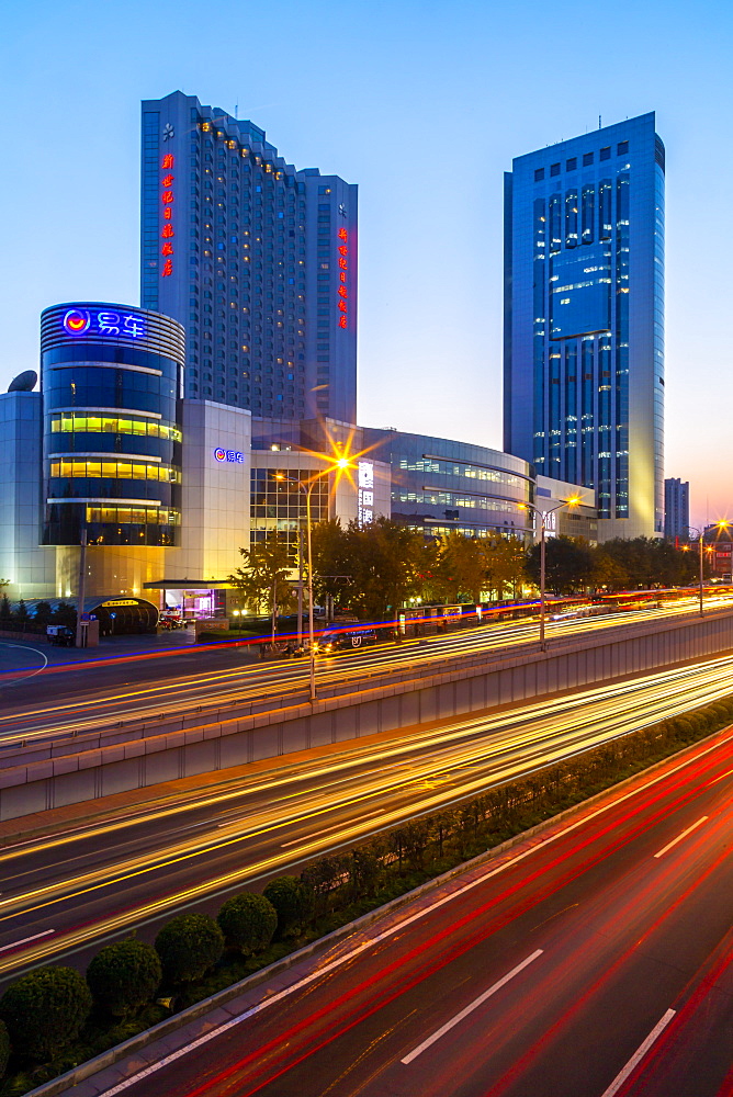 Traffic trail lights on major road near Beijing Zoo at dusk, Beijing, People's Republic of China, Asia