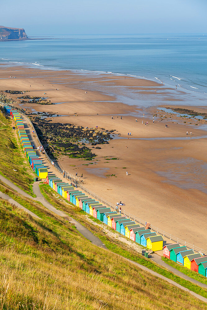 View of colourful beach huts on West Cliff Beach, Whitby, North Yorkshire, England, United Kingdom, Europe