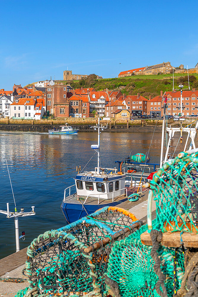 View of St. Mary's Church and fishing baskets, houses and boats on the River Esk, Whitby, Yorkshire, England, United Kingdom, Europe