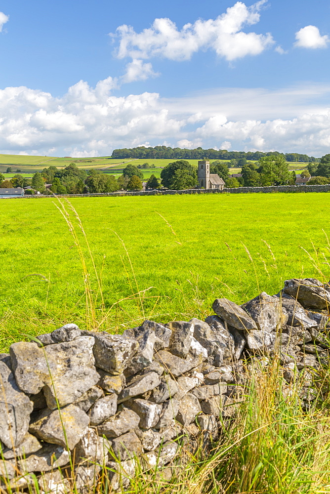 View of village church and dry stone walls, Biggin, Peak District National Park, Derbyshire, England, United Kingdom, Europe