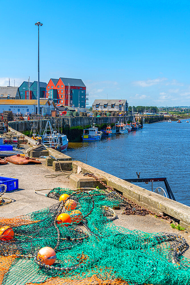 View of fishing nets on quayside and River Coquet at Amble, Morpeth, Northumberland, England, United Kingdom, Europe