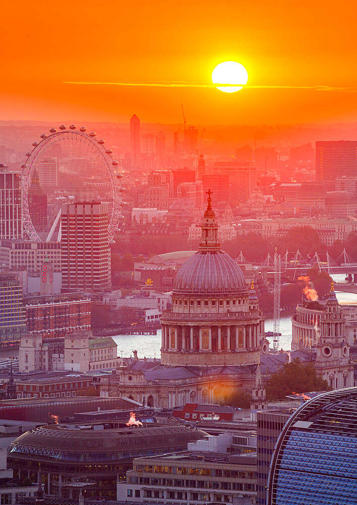 View of sun setting over London Eye and St. Paul's Cathedral from the Principal Tower, London, England, United Kingdom, Europe