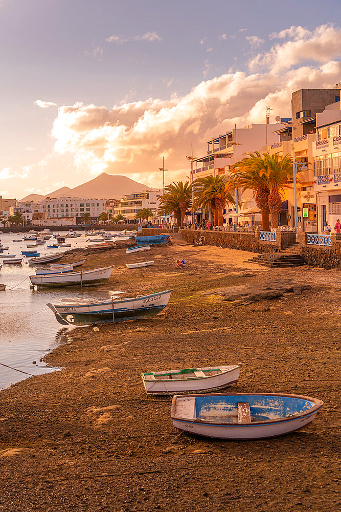 View of boats on beach in Baha de Arrecife Marina surrounded by shops, bars and restaurants at sunset, Arrecife, Lanzarote, Canary Islands, Spain, Atlantic, Europe