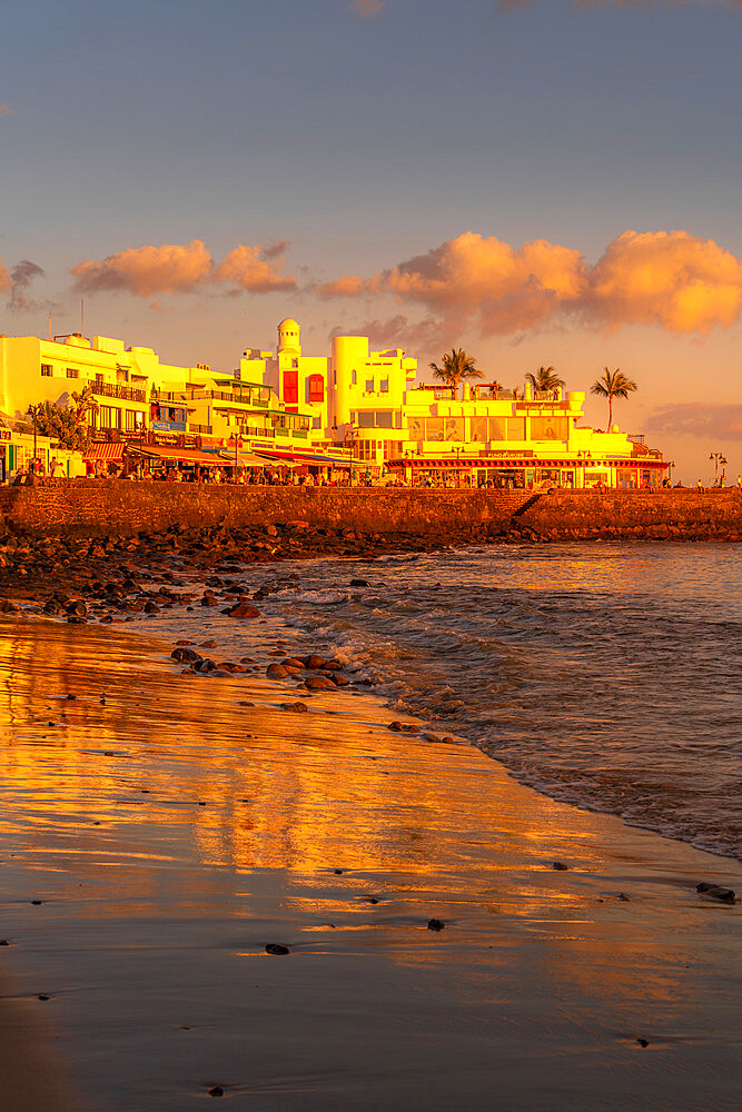 View of beach and cafes and bars during golden hour, Playa Blanca, Lanzarote, Canary Islands, Spain, Atlantic, Europe