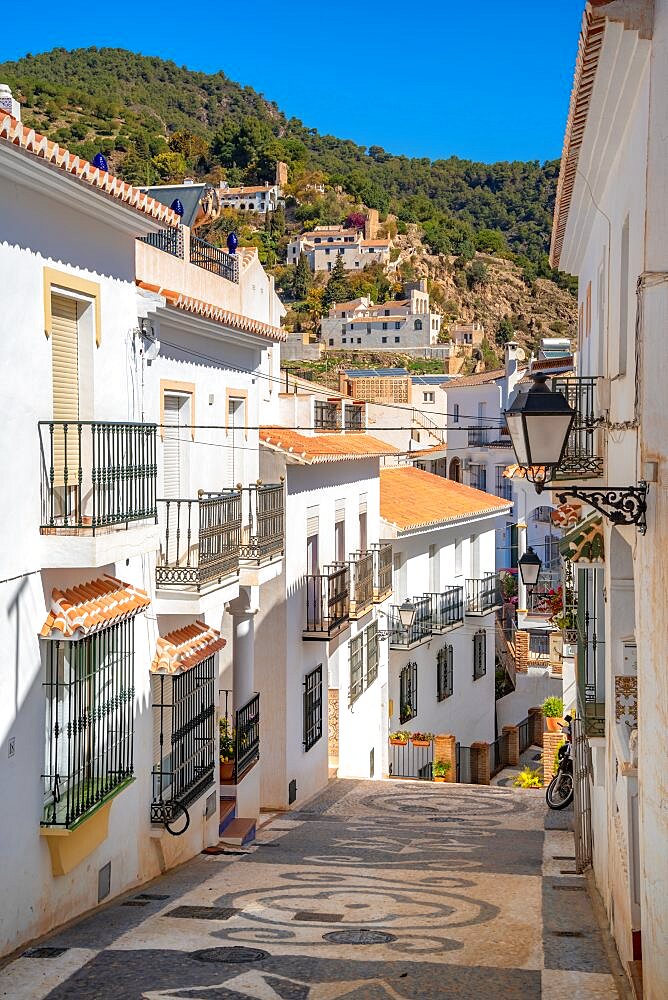 View of white washed houses and mountains in background, Frigiliana, Malaga Province, Andalucia, Spain, Europe