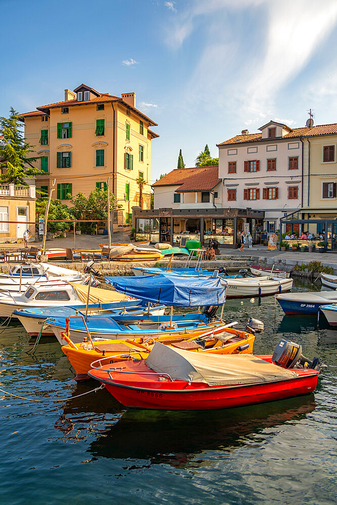 View of boats in the marina and harbourside restaurants during golden hour in Volosko, Opatija, Kvarner Bay, Croatia, Europe