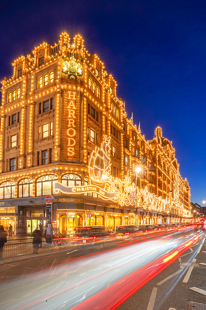 View of Harrods department store illuminated at dusk, Knightsbridge, London, England, United Kingdom, Europe