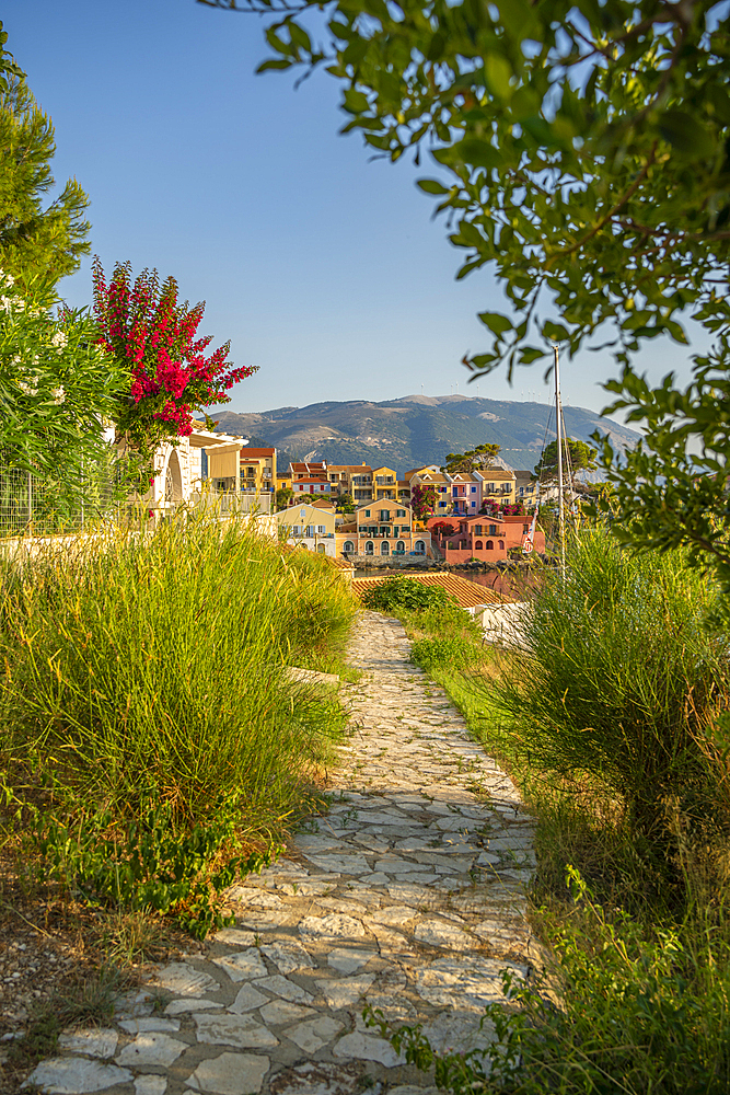 Path leading to harbour and colourful houses in Assos, Assos, Kefalonia, Ionian Islands, Greek Islands, Greece, Europe