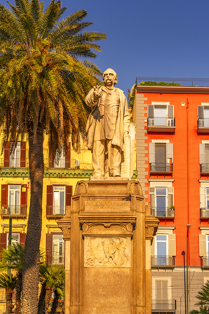 View of Nicola Amore statue and colourful architecture in Piazza della Vittoria, Naples, Campania, Italy, Europe