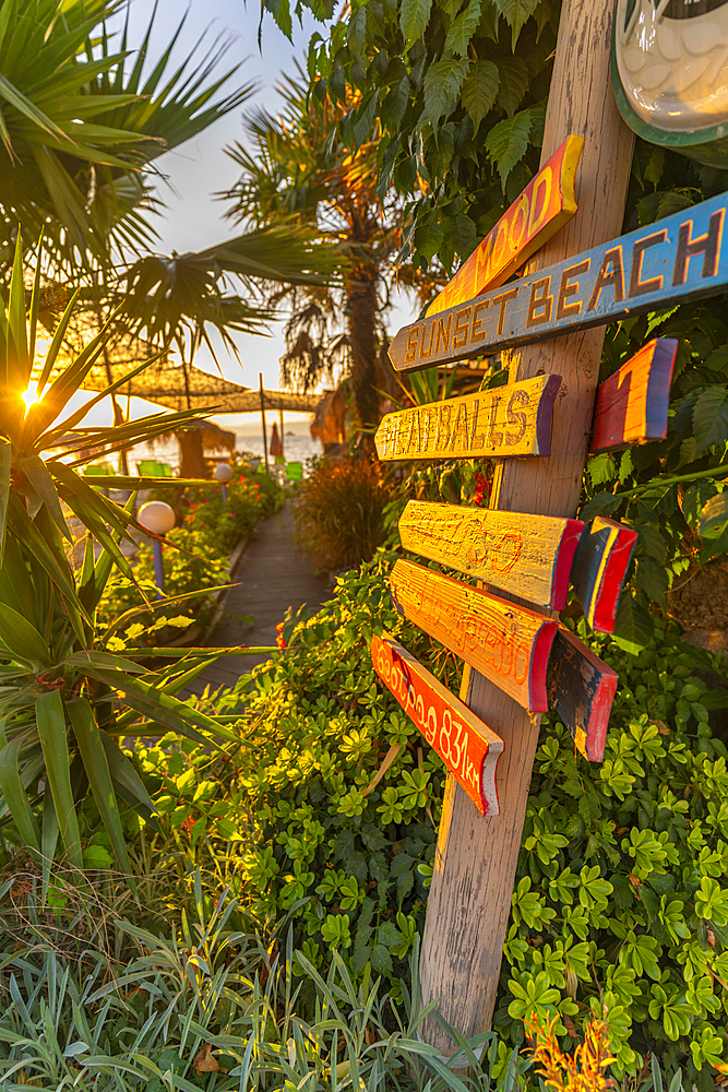 View of signpost in old harbour in Thassos Town during golden hour, Thassos, Aegean Sea, Greek Islands, Greece, Europe