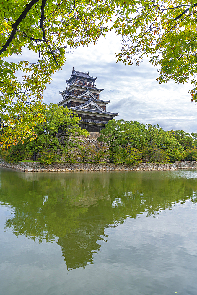 View of Hiroshima Castle, with museum, reflecting in Moat, Motomachi, Naka Ward, Hiroshima, Honshu, Japan