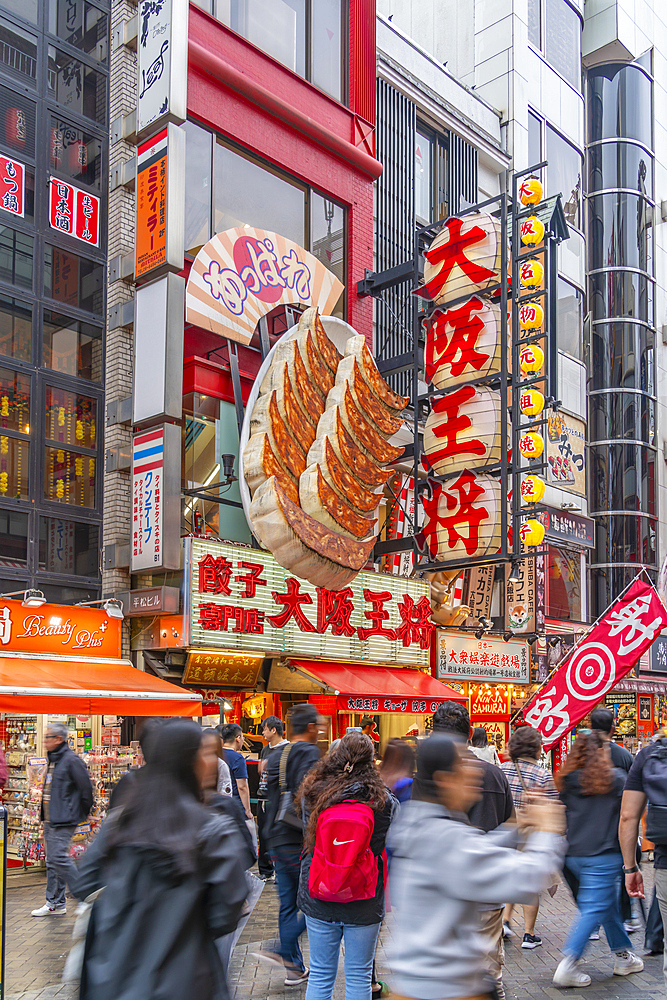 View of colourful facades of restaurants in Dotonbori, vibrant entertainment district near the river, Osaka, Honshu, Japan