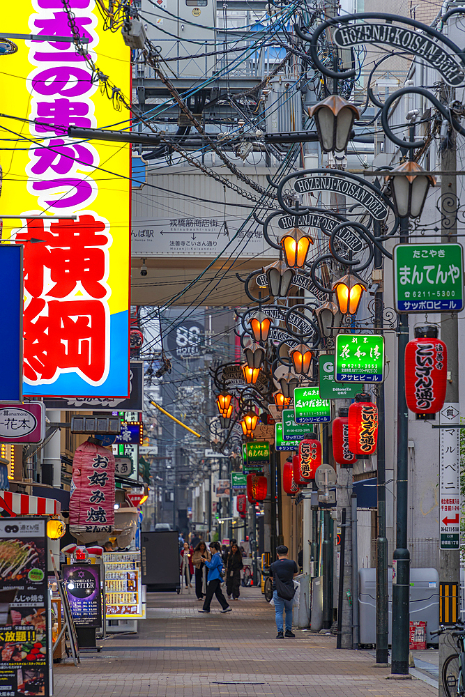 View of colourful signs in backstreet in Dotonbori, vibrant entertainment district near the river, Osaka, Honshu, Japan