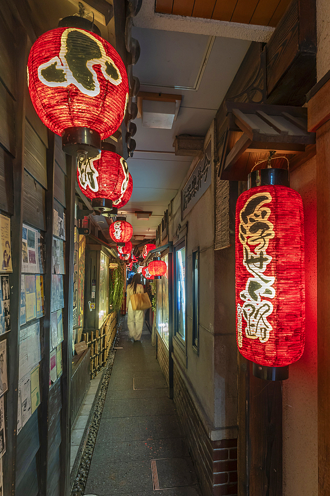 View of Japanese lanterns in dark alleyway in Dotonbori, vibrant entertainment district near the river, Osaka, Honshu, Japan